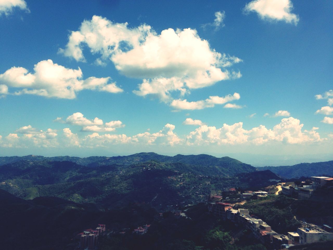 sky, building exterior, built structure, architecture, mountain, cityscape, cloud - sky, city, high angle view, cloud, crowded, mountain range, residential district, blue, town, landscape, scenics, residential structure, residential building, tree