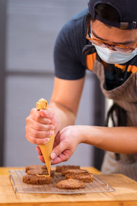 Midsection of man holding ice cream