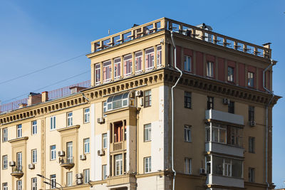 Low angle view of buildings against blue sky