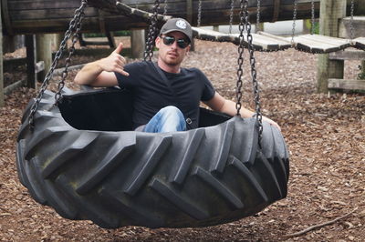 Portrait of boy swinging at playground