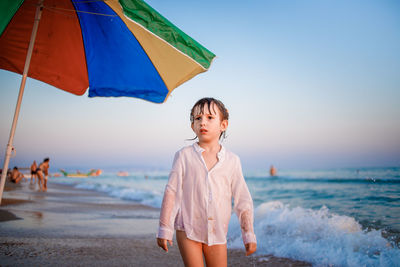 Boy on beach against sky