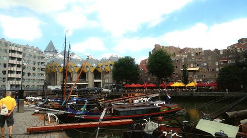 Boats moored in river against buildings in city