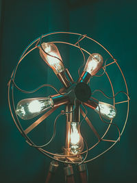 Close-up of illuminated antique electric fan