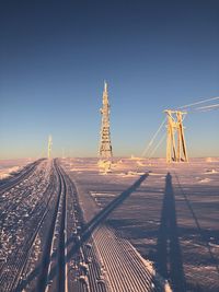 Winter landscape against clear blue sky