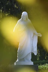 Low angle view of statue against yellow sky