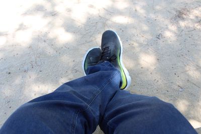 Low section of man standing on ground