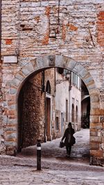 Rear view of woman walking in historic building