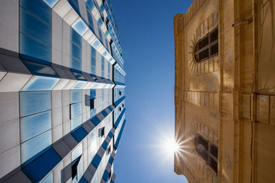 Low angle view of buildings against clear blue sky