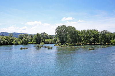 Scenic view of lake against cloudy sky