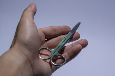 Midsection of person holding hands against blue background