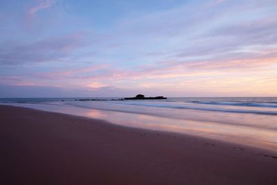 Scenic view of beach against sky during sunset