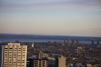 High angle view of buildings by sea against sky