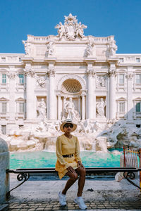 Man statue in front of historical building