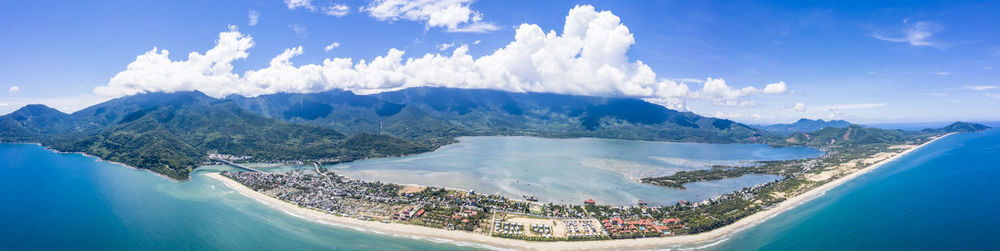 Panoramic view of sea and mountains against sky