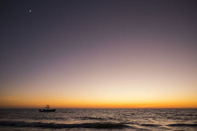 Scenic view of sea against clear sky during sunset