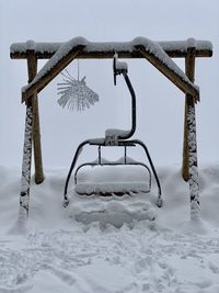 Metallic structure on snow covered field