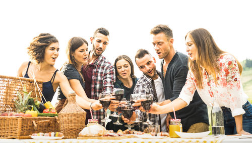 Group of people at restaurant against clear sky