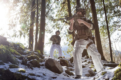 Low angle view of man standing in forest