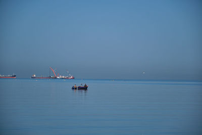 The small fisherman boat in the sea. a small fisherman boat floating on the sea near the seashore