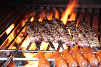 Skewers with meat on cooking on barbecue grill