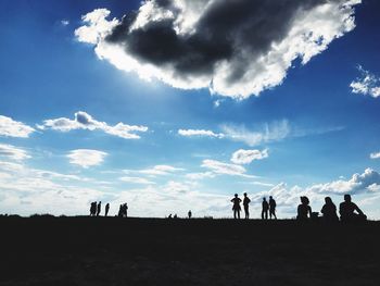 Low angle view of silhouette people against sky