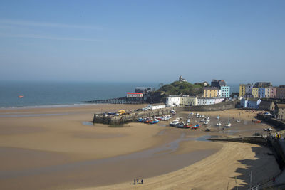 Panoramic view of beach by city against clear sky