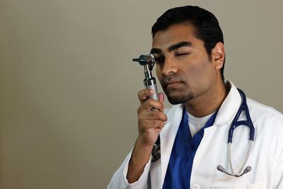 Close-up of young man holding camera