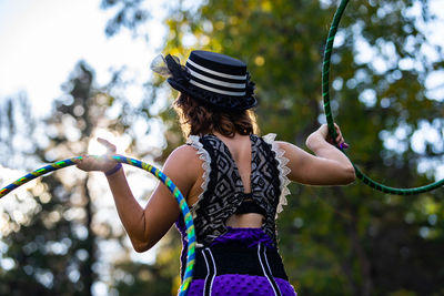 Rear view of woman holding umbrella