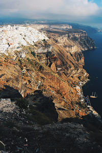 High angle view of rocks by sea against sky
