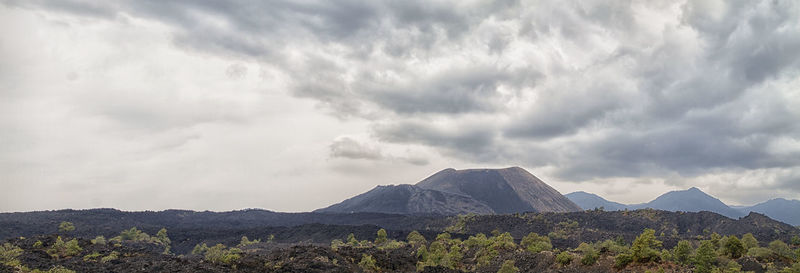Scenic view of mountains against cloudy sky