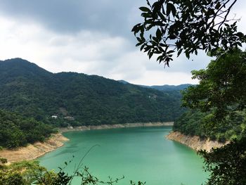 Scenic view of lake and mountains against sky