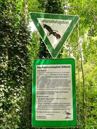 Information sign board on tree trunk