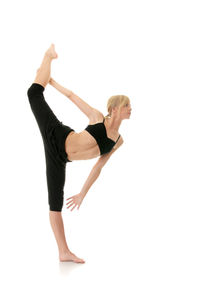 Midsection of woman with arms raised against white background