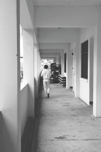 Rear view of man in corridor