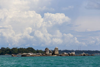 Panoramic view of sea and rocks against sky