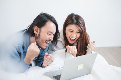 Smiling young woman using mobile phone