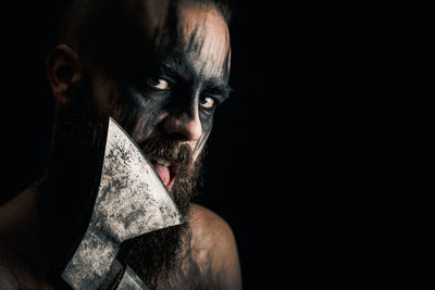 Portrait of man against black background