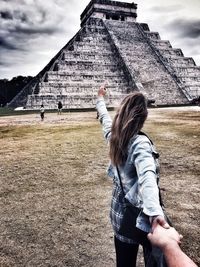 Midsection of woman standing against the sky