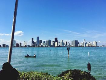 Sea and cityscape against sky