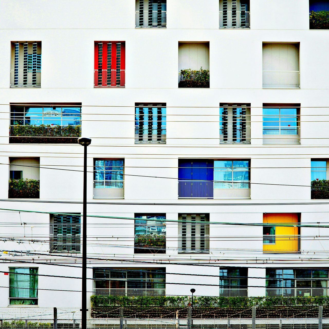 building exterior, architecture, built structure, window, full frame, building, residential building, city, backgrounds, residential structure, glass - material, balcony, facade, apartment, day, low angle view, outdoors, repetition, in a row, reflection