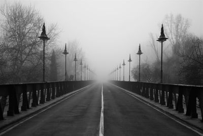 Rear view of woman walking on footbridge