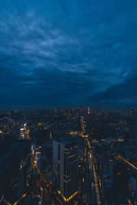 High angle view of illuminated cityscape against sky at night