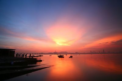 Scenic view of calm sea against sky at sunset