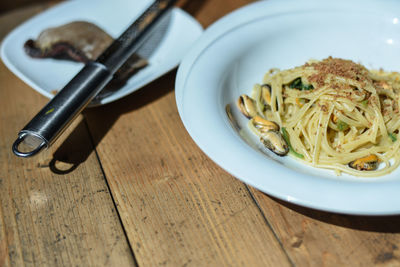 High angle view of pasta served in plate on wooden table