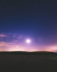 Scenic view of landscape against sky at night