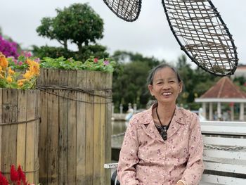 Portrait of smiling woman sitting outdoors