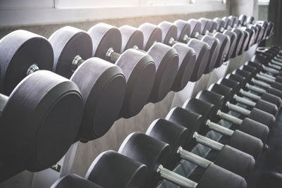 Dumbbells in the gym at sports club for exercise and bodybuilding.