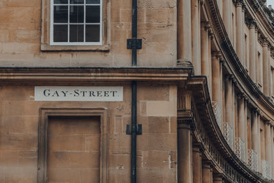 Street name sign on a wall of stone building on gay street in bath, somerset, uk.