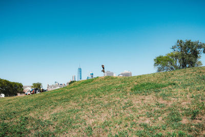 Scenic view of field against clear blue sky