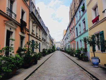 Street amidst buildings against sky